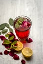 Popular Indian/Asian sharbat i.e GULAB KA SHARBAT with sliced lemon,Citrus Ãâ limon,Rosa,rose petals and mint leaves on a silver